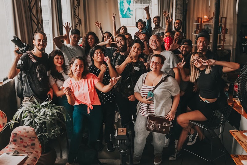 A group of people smiling and waving.